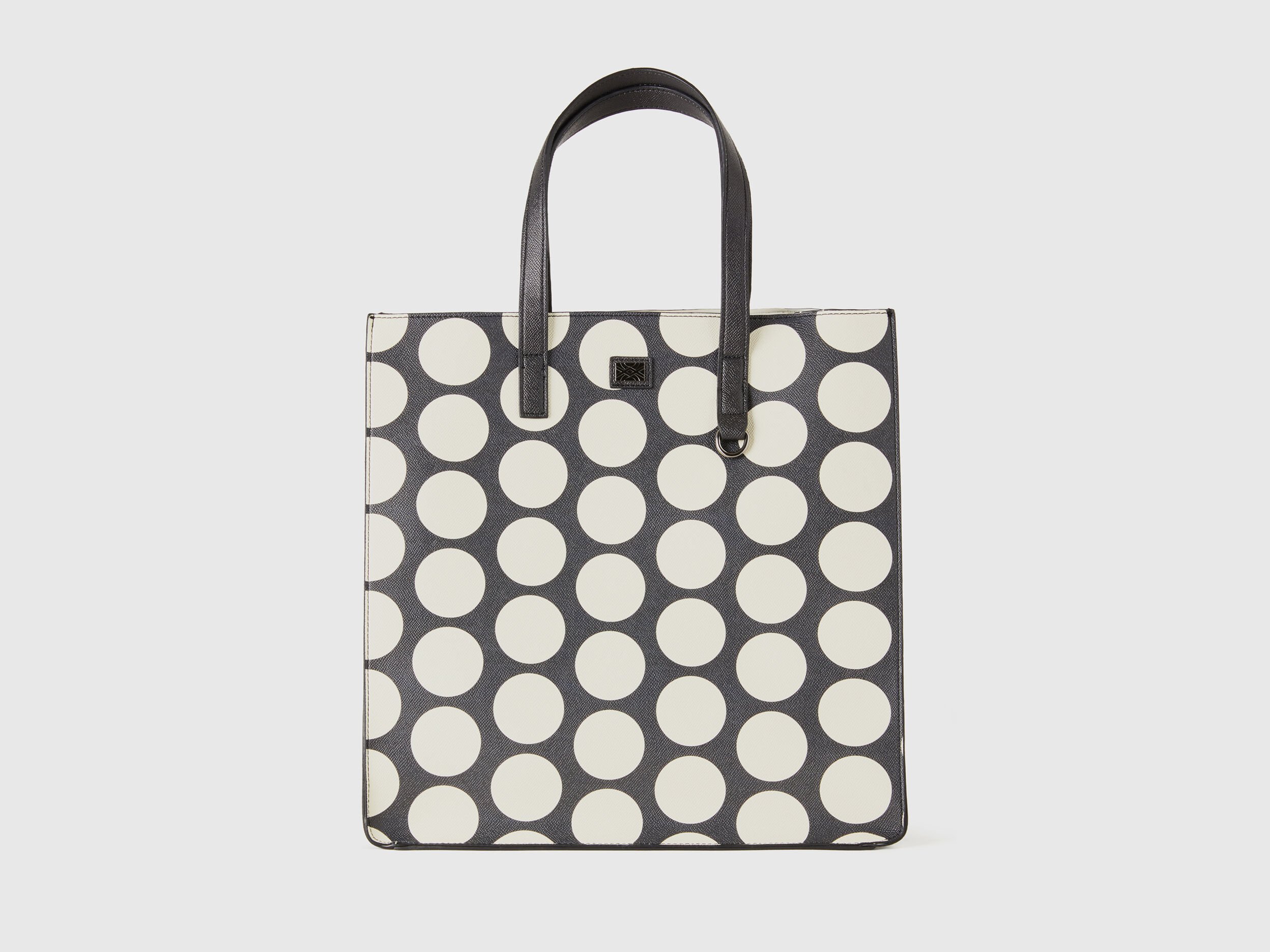 Black shopping bag with white polka dots