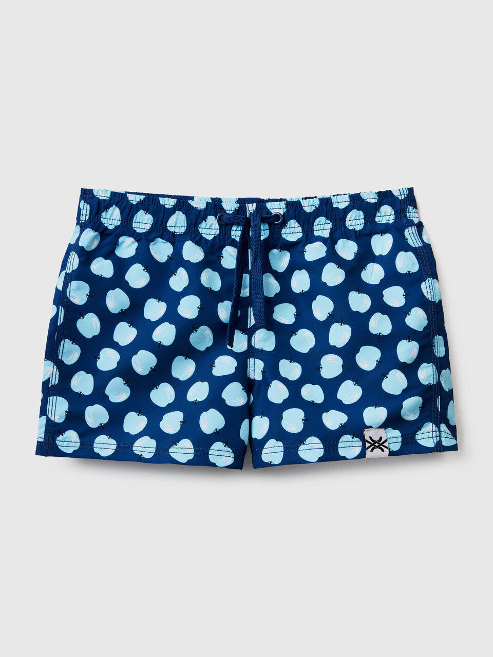 Dark blue swim trunks with apple pattern