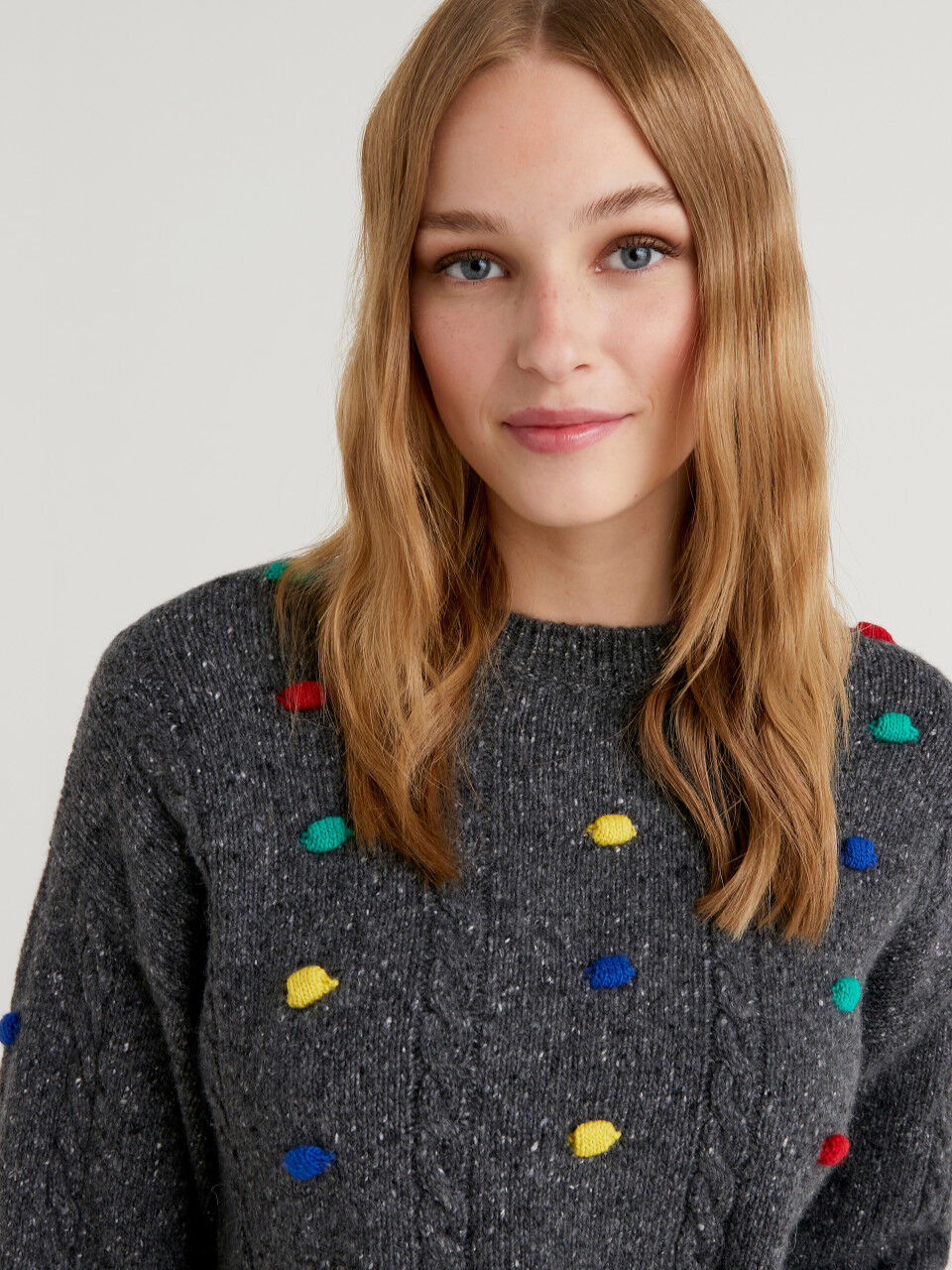 JCCxUCB sweater with pom pom